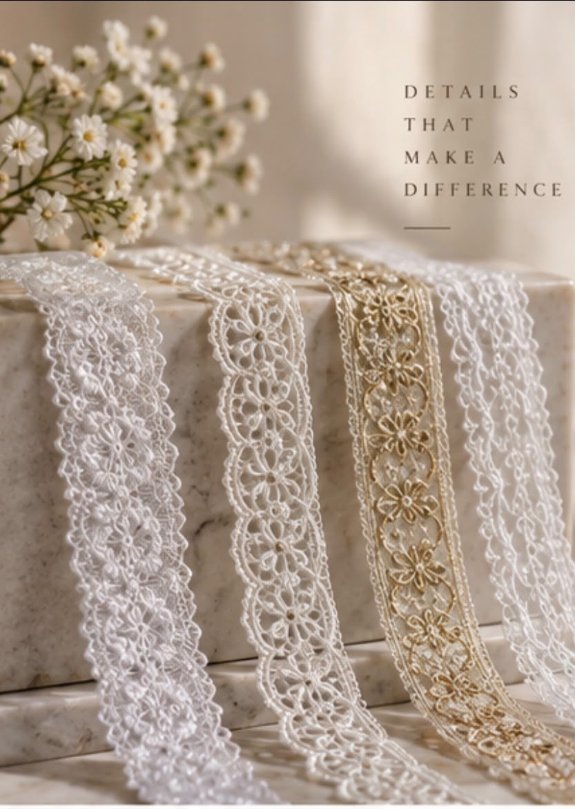 Delicate white and gold lace ribbons arranged on marble